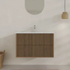 Meuble de salle de bain suspendu avec façade crantée et vasque encastrée