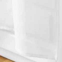Paire de voilages passe-tringle en voile sablé avec finitions pompons