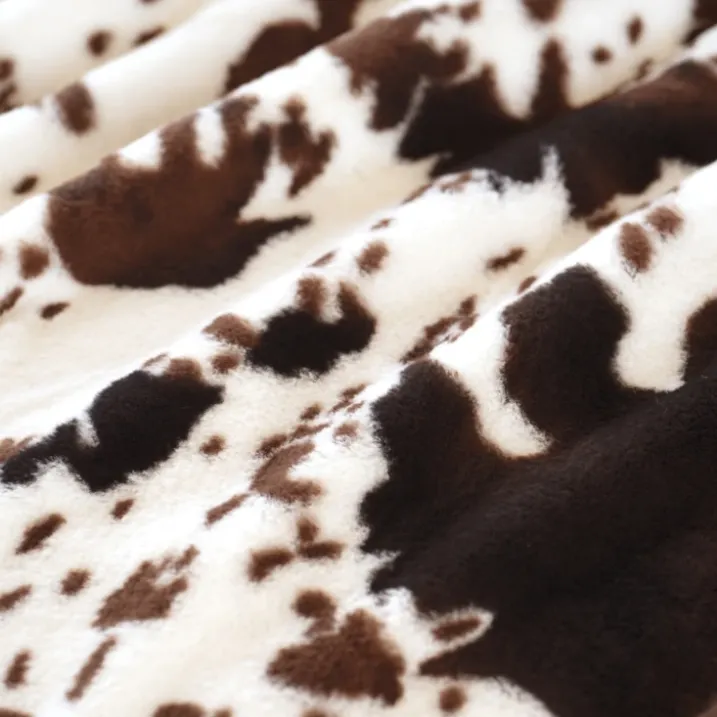 Plaid doux à motif peau de vache avec dos en velours
